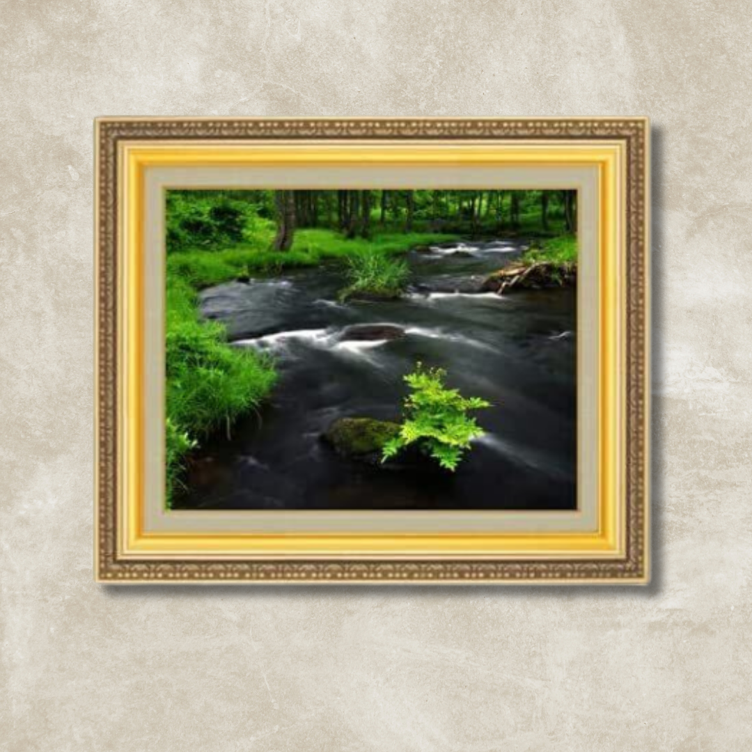 Landscape painting of a babbling brook in a gold frame